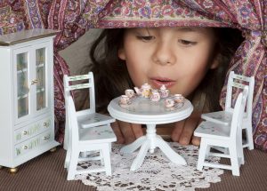 Alice in wonderland looking through a miniature window